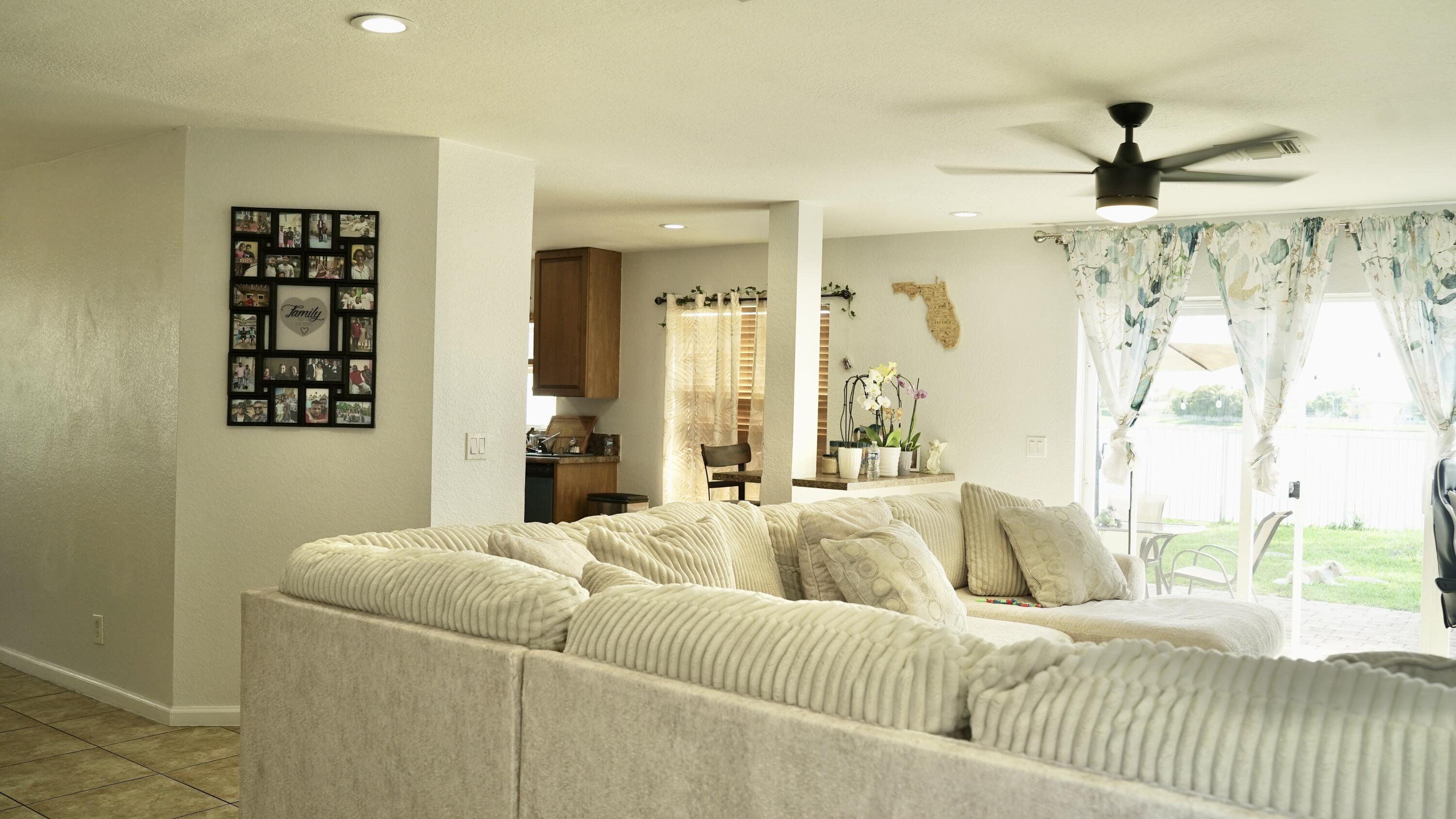 3290 Turtle Cove West Palm Beach, FL 33411 - Photo 12 of 55 a living room with furniture and a large window