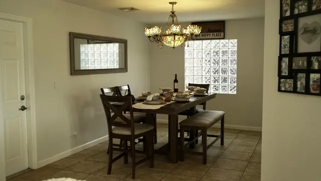a view of a dining room with furniture and a chandelier