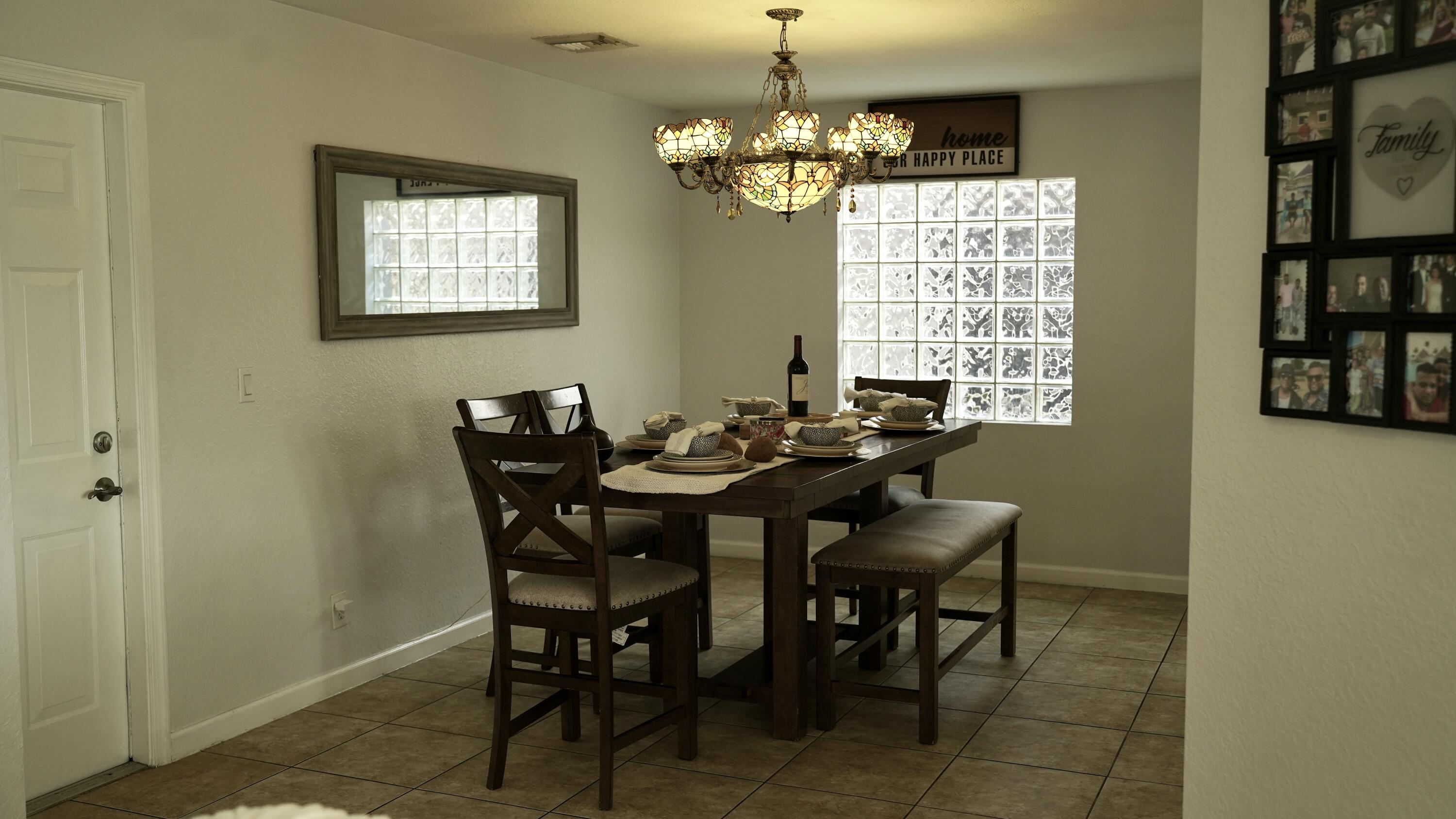 3290 Turtle Cove West Palm Beach, FL 33411 - Photo 15 of 55 a view of a dining room with furniture and a chandelier