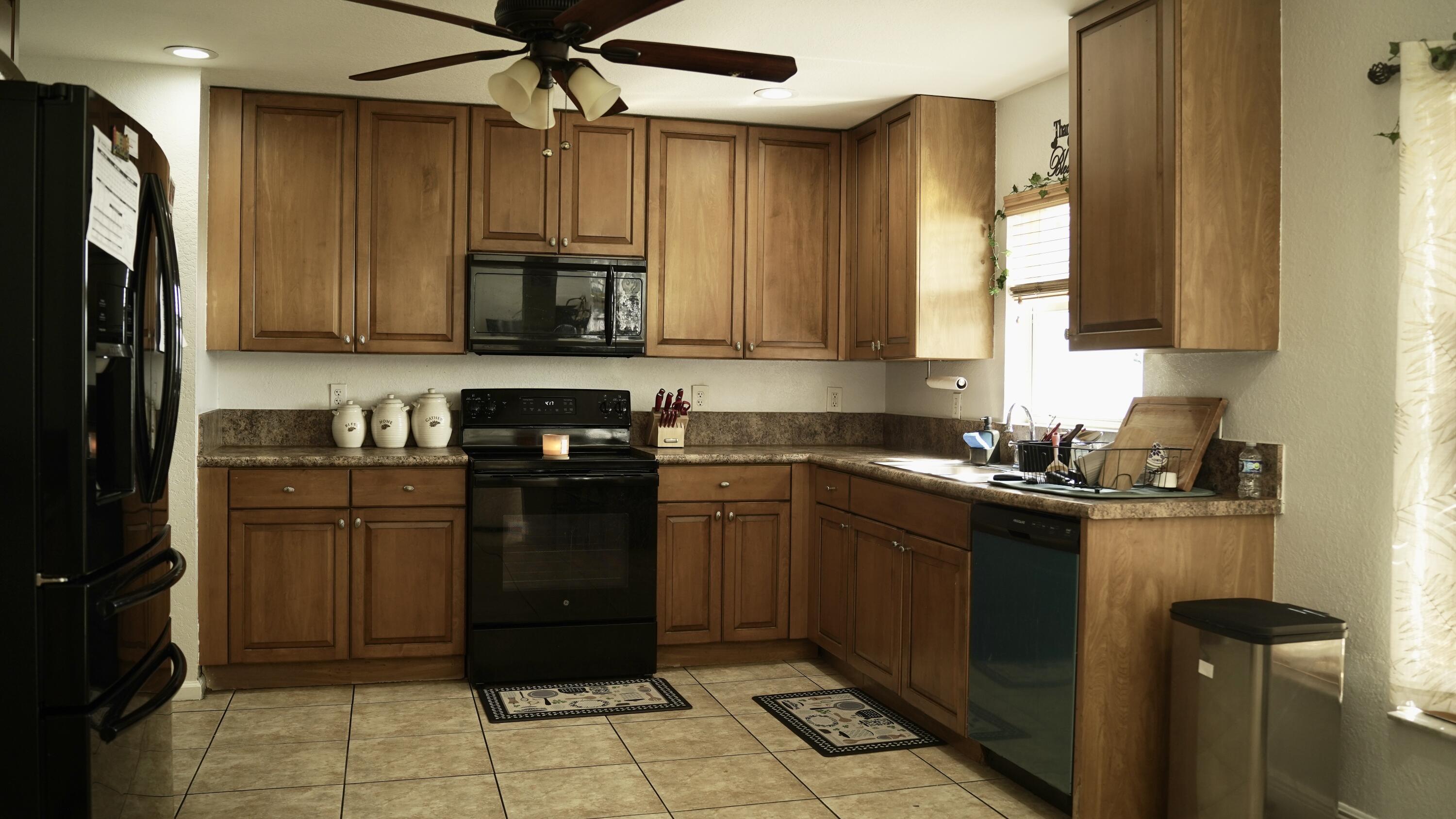 3290 Turtle Cove West Palm Beach, FL 33411 - Photo 16 of 55 a kitchen with a refrigerator and a sink