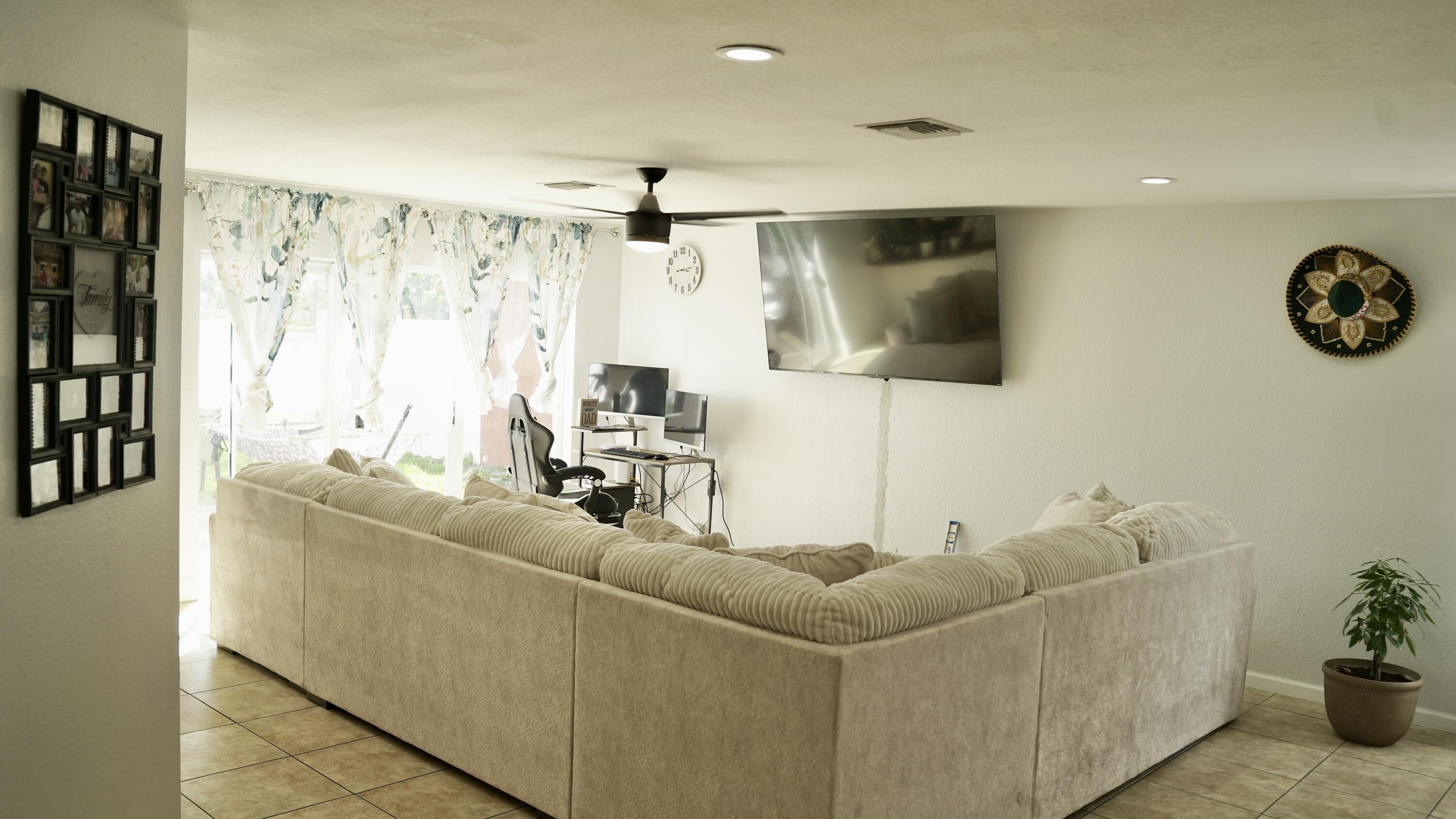 3290 Turtle Cove West Palm Beach, FL 33411 - Photo 20 of 55 a living room with furniture and a flat screen tv