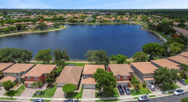 an aerial view of residential houses with outdoor space and river