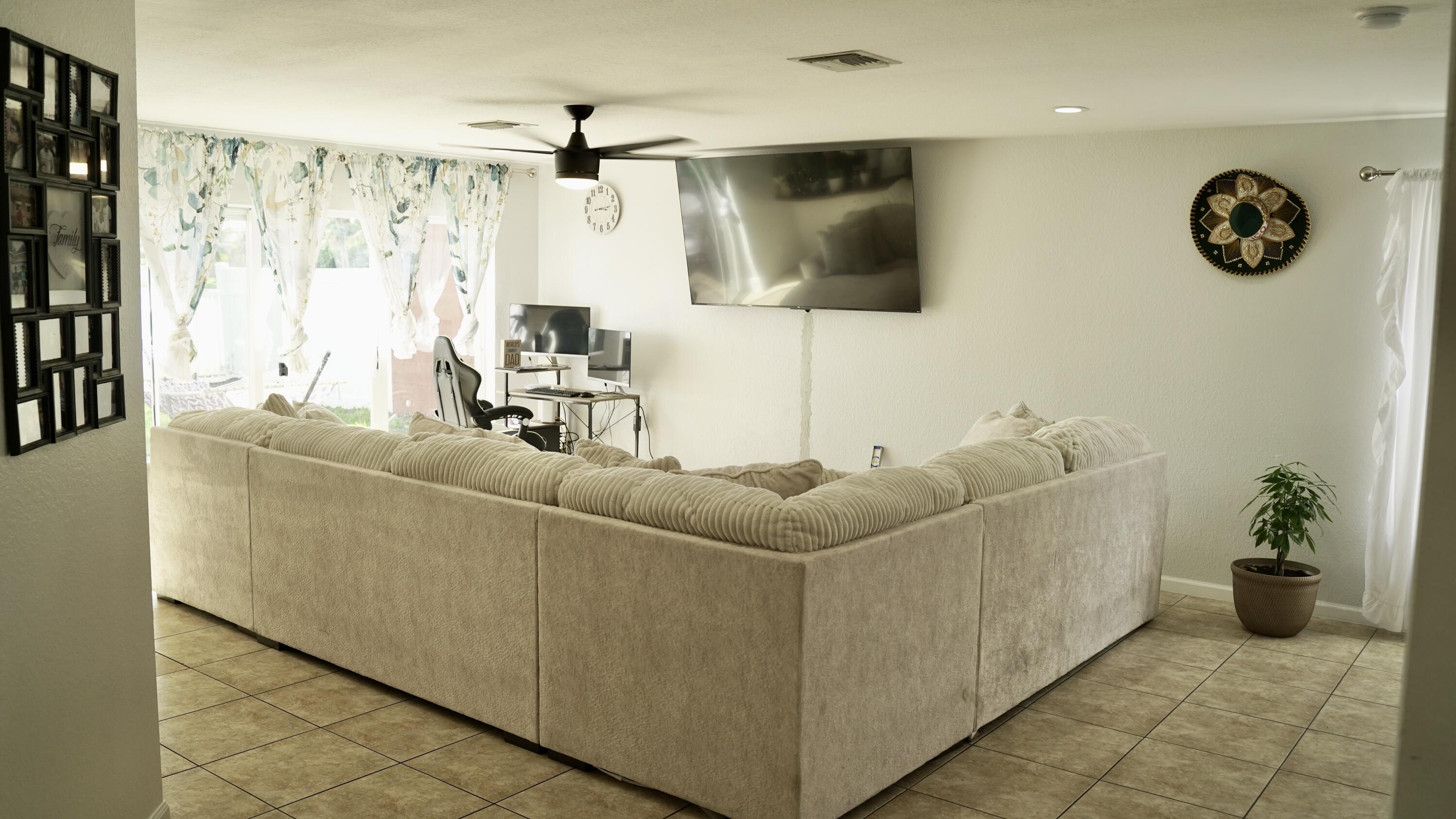 3290 Turtle Cove West Palm Beach, FL 33411 - Photo 21 of 55 a living room with furniture and a flat screen tv