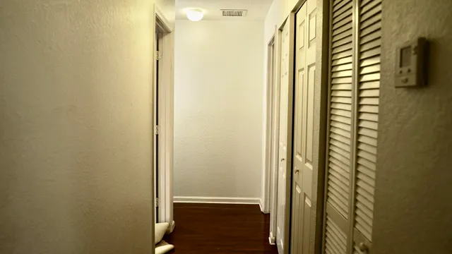 a bedroom with a bed a dresser and mirror