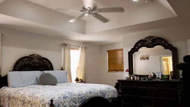 a bedroom with a bed and a window