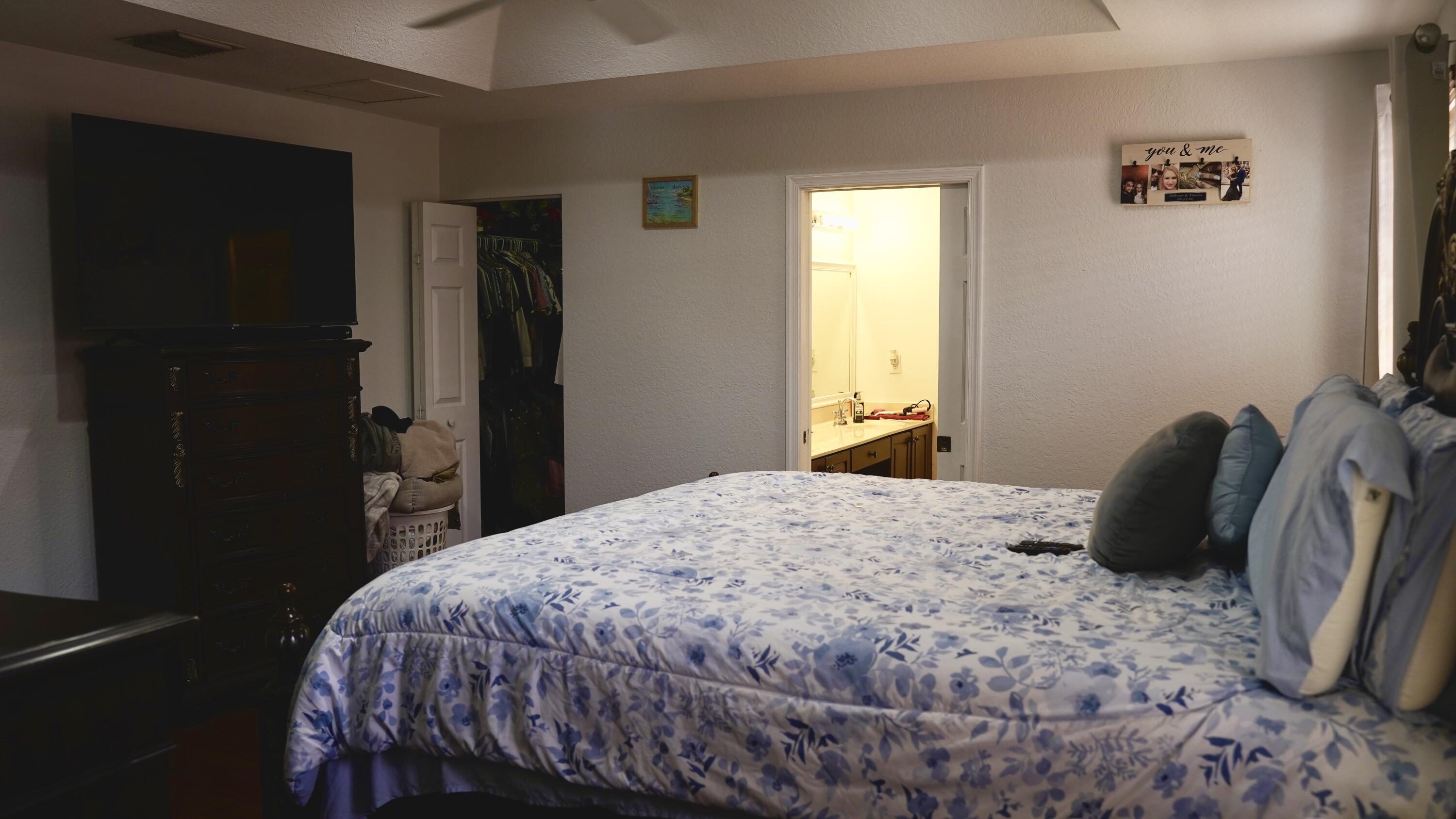 3290 Turtle Cove West Palm Beach, FL 33411 - Photo 29 of 55 a bedroom with a bed and wooden floor