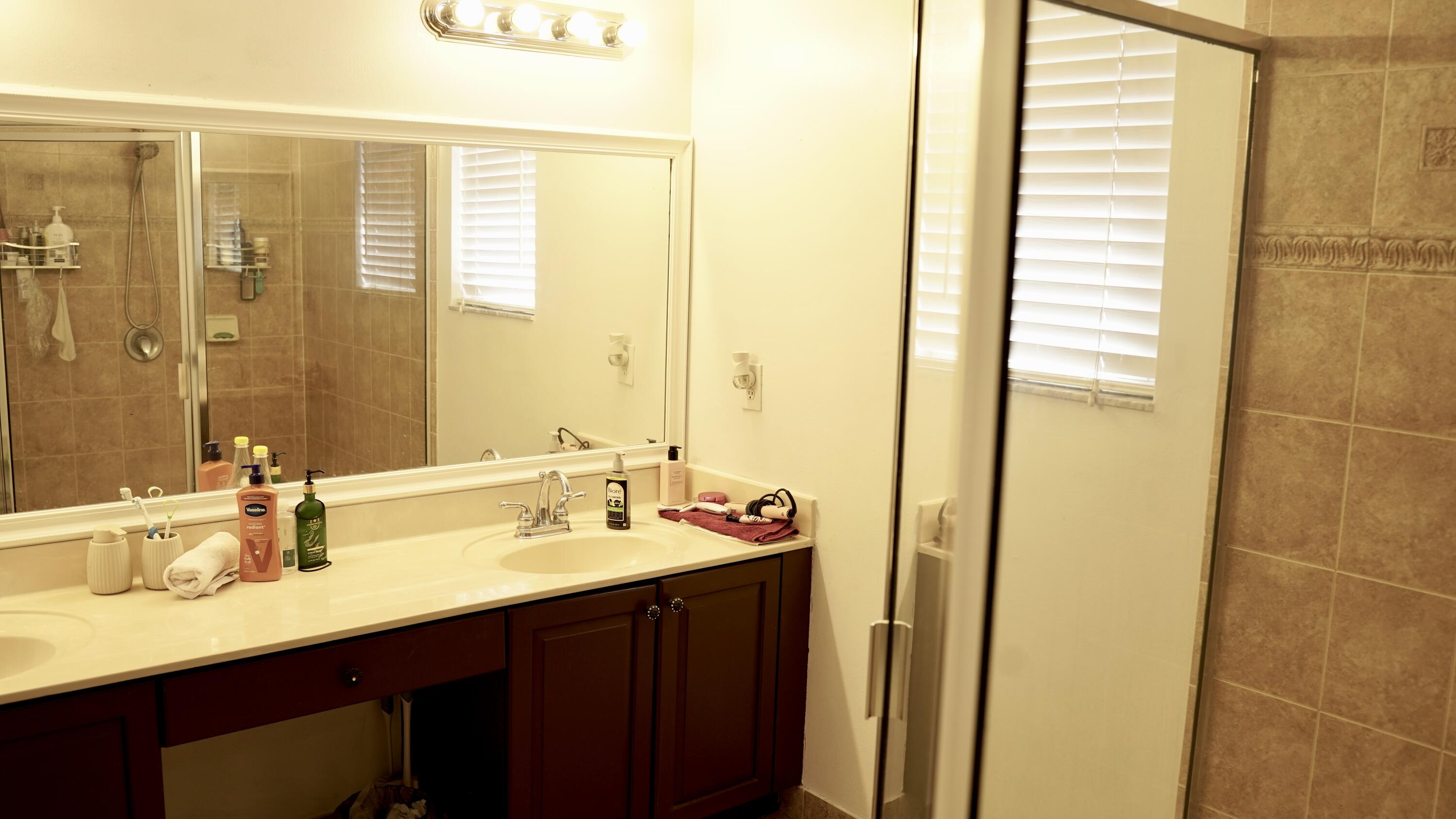 3290 Turtle Cove West Palm Beach, FL 33411 - Photo 30 of 55 a bathroom with a sink and a mirror