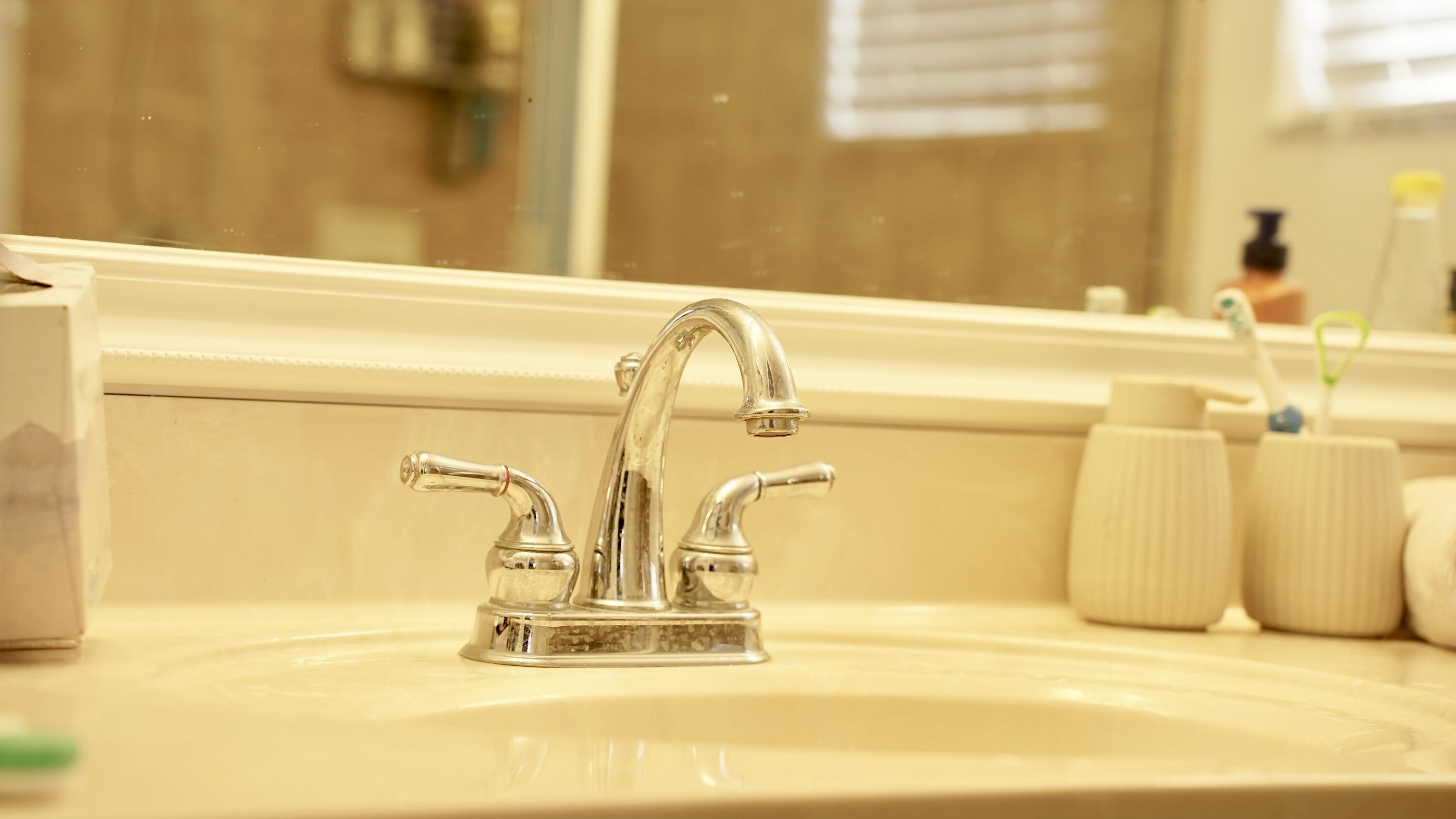 3290 Turtle Cove West Palm Beach, FL 33411 - Photo 31 of 55 a bathroom with a granite countertop sink and a mirror