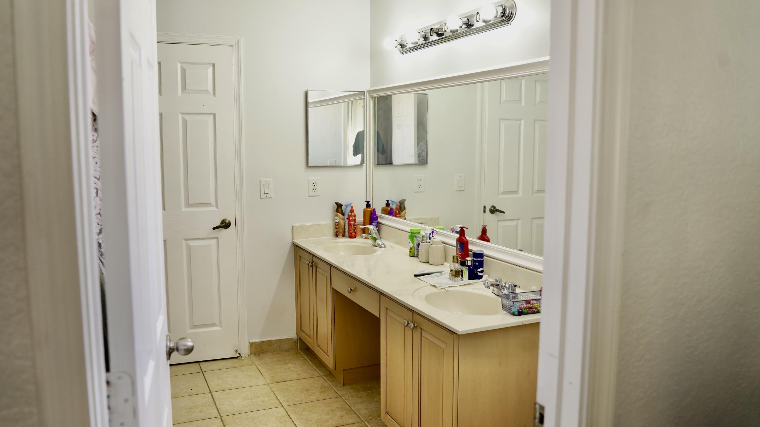 3290 Turtle Cove West Palm Beach, FL 33411 - Photo 39 of 55 a bathroom with a sink and a mirror
