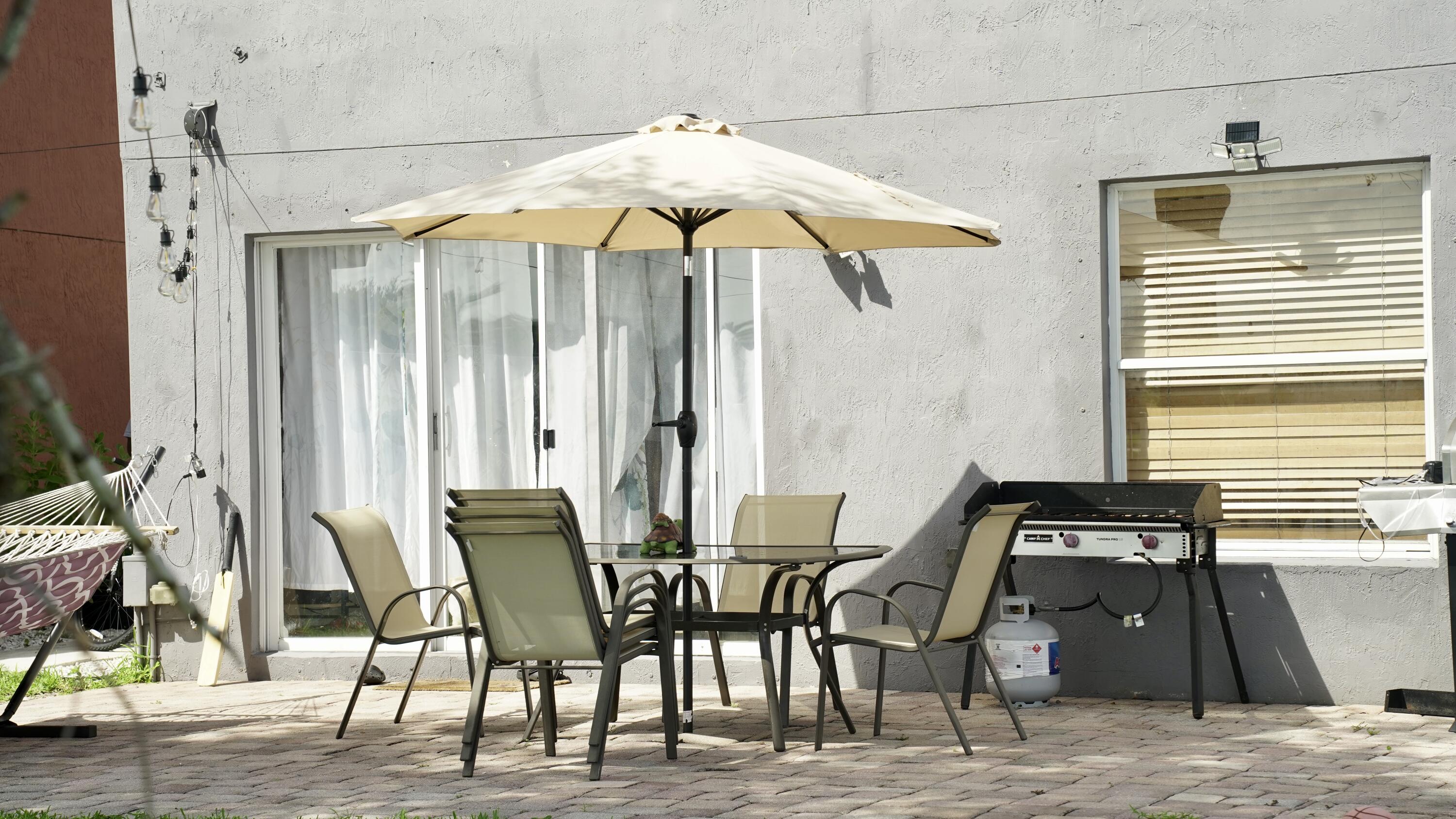 3290 Turtle Cove West Palm Beach, FL 33411 - Photo 46 of 55 a table and chairs in a patio