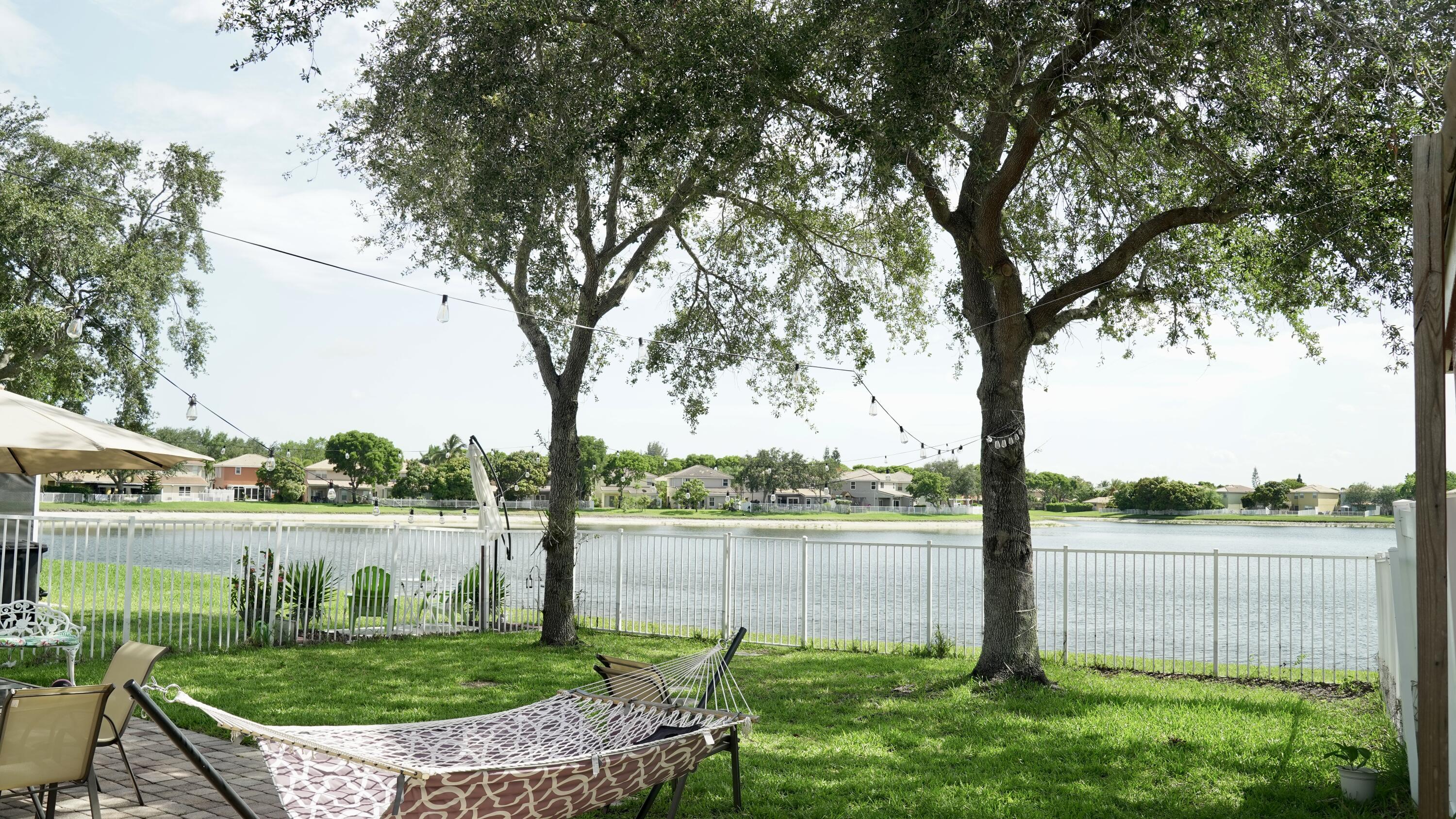 3290 Turtle Cove West Palm Beach, FL 33411 - Photo 47 of 55 a view of a lake with a big yard and large trees