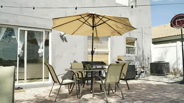 a backyard of a house with lots of green space and fountain