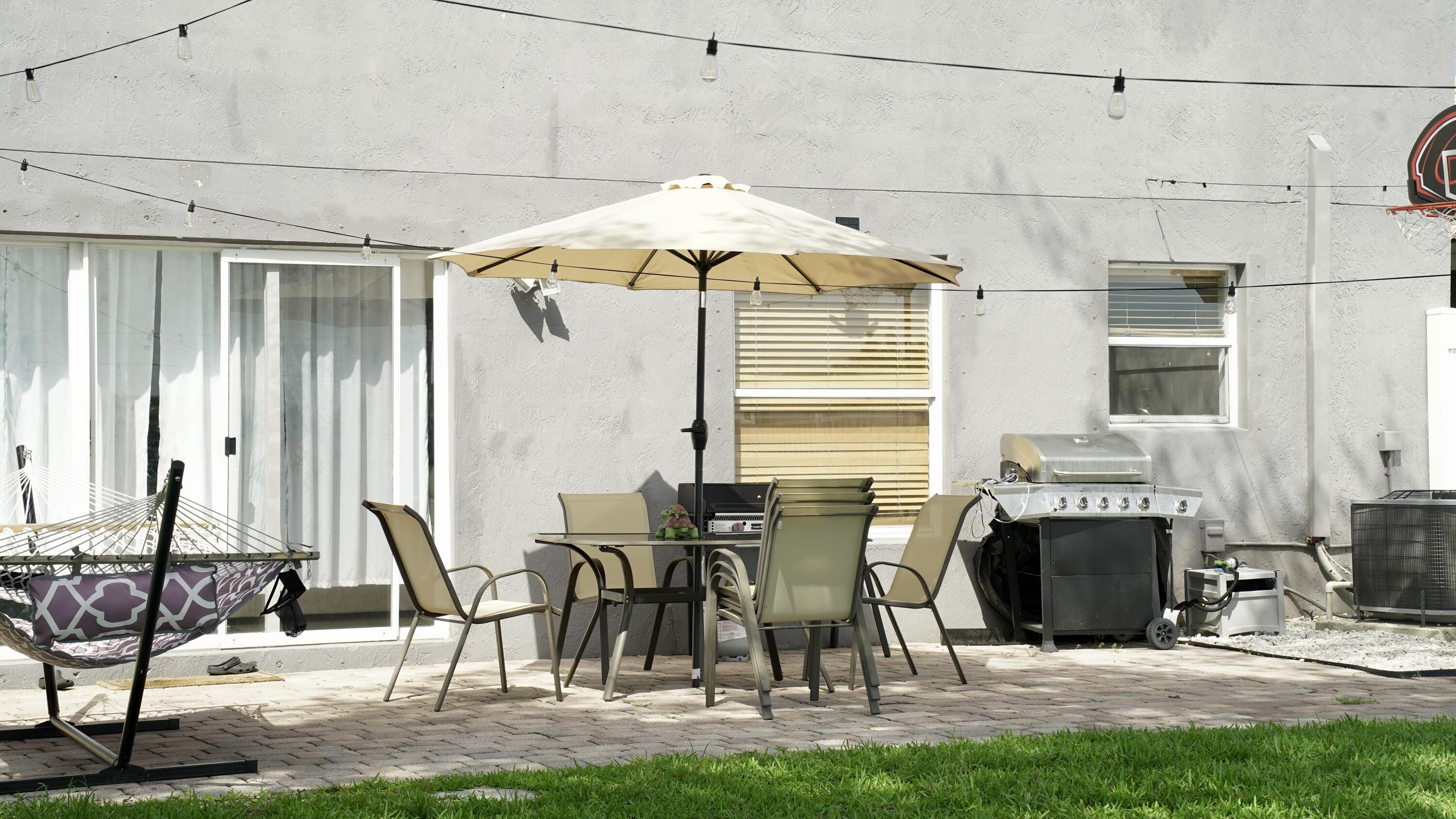 3290 Turtle Cove West Palm Beach, FL 33411 - Photo 49 of 55 a patio with table and chairs