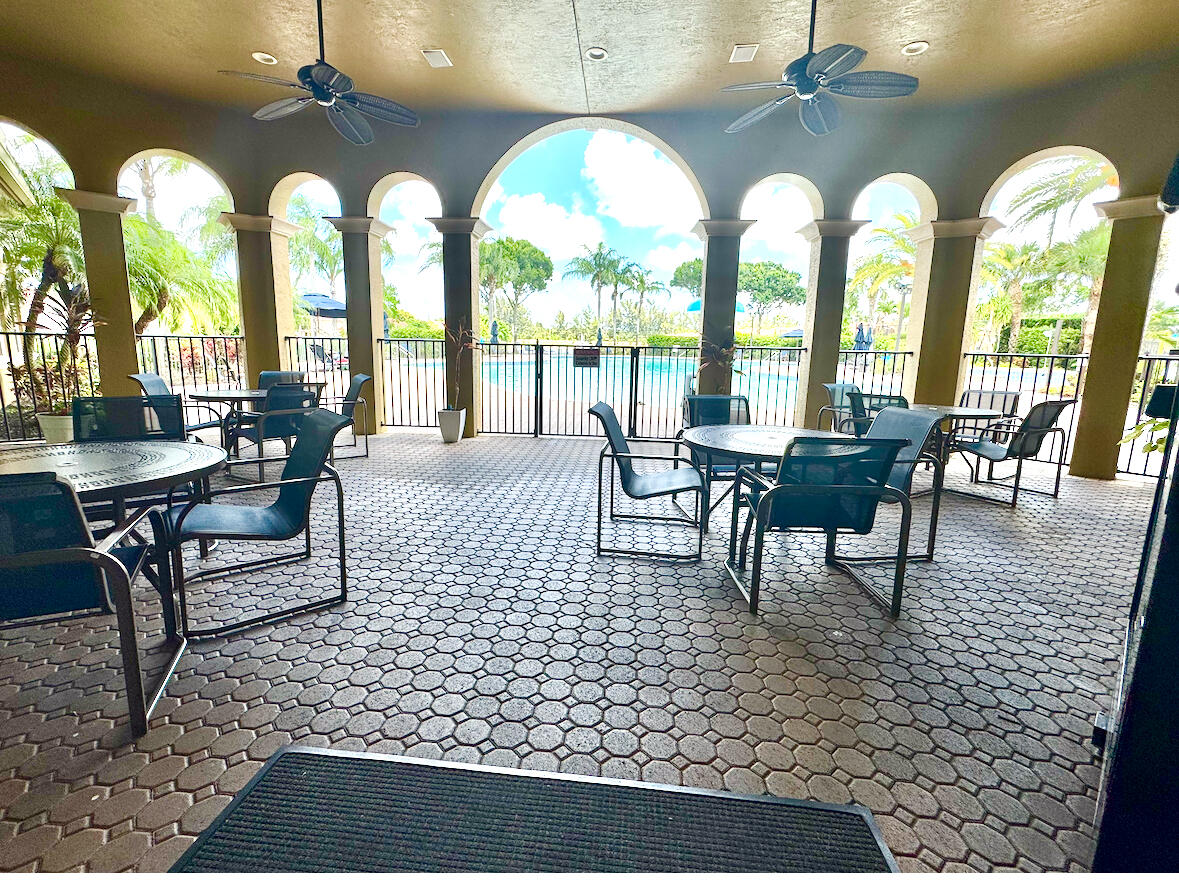 3290 Turtle Cove West Palm Beach, FL 33411 - Photo 55 of 55 a view of a dining room with furniture large windows and wooden floor