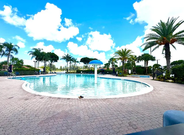 a view of a swimming pool with a yard