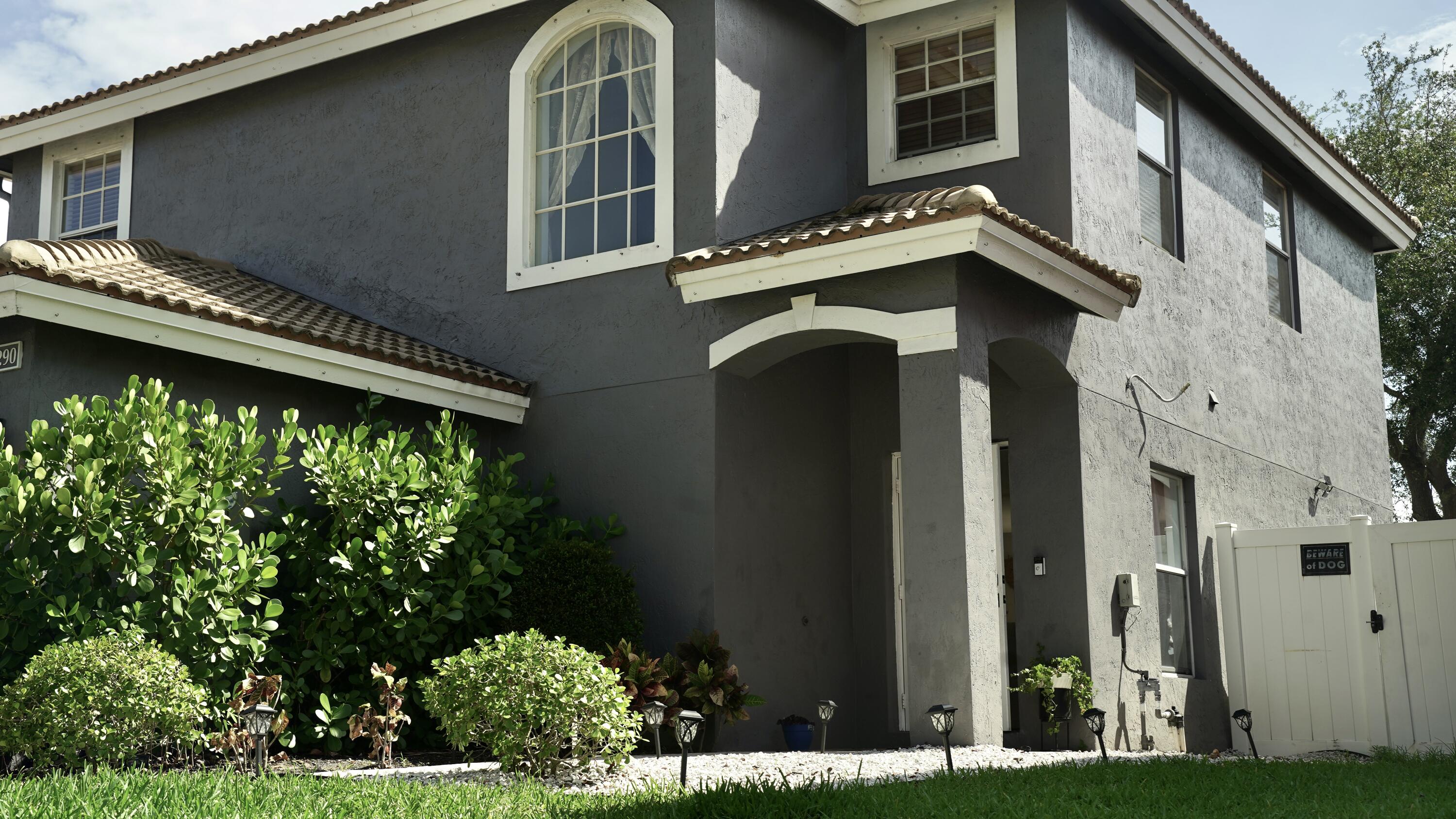 3290 Turtle Cove West Palm Beach, FL 33411 - Photo 9 of 55 a front view of a house with a garden
