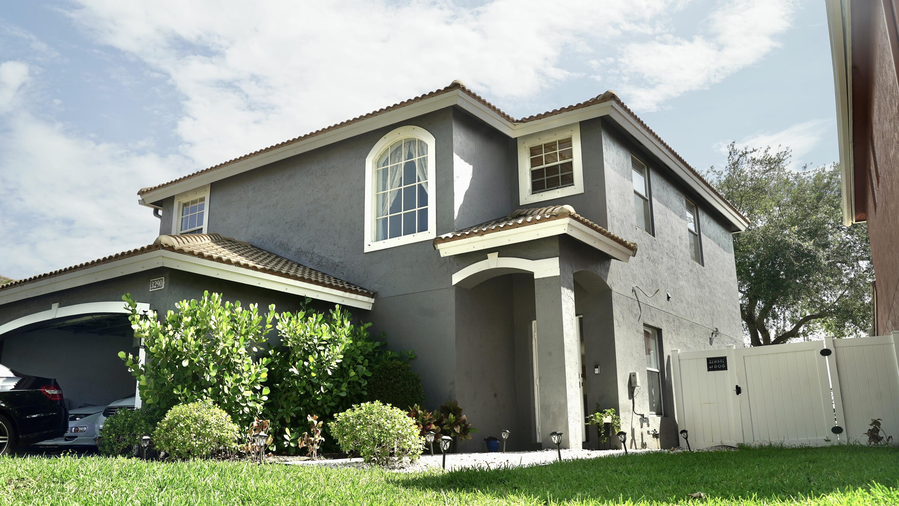 3290 Turtle Cove West Palm Beach, FL 33411 - Photo 10 of 55 a front view of a house with a yard