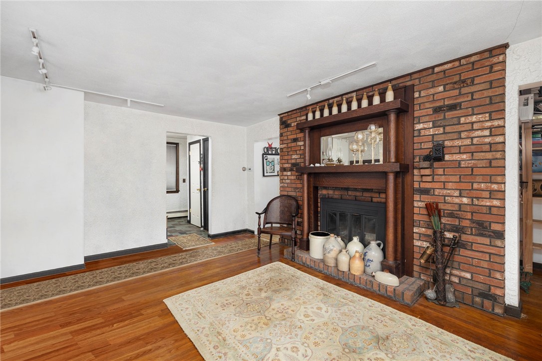 786 Sandy Lane Warwick, RI 02889 - Photo 10 of 26 A large, wood burning fireplace anchors the living room.