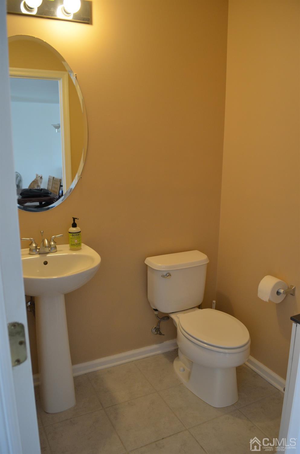 37 Rojewski Way, Unit 1471 Sayreville, NJ 08859 - Photo 22 of 28 a bathroom with a toilet sink and mirror