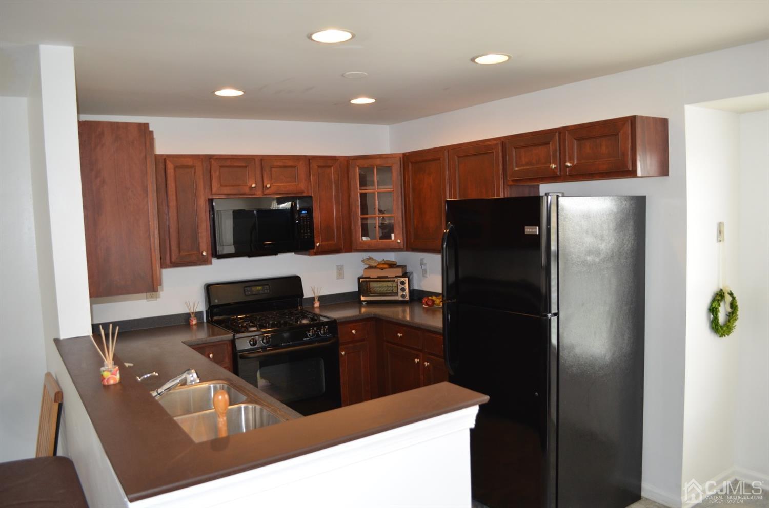 37 Rojewski Way, Unit 1471 Sayreville, NJ 08859 - Photo 8 of 28 a kitchen with stainless steel appliances granite countertop a refrigerator and a stove