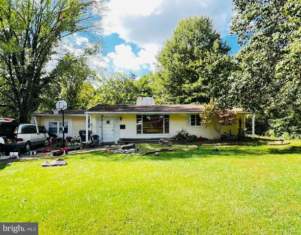 a view of a house with swimming pool and sitting area