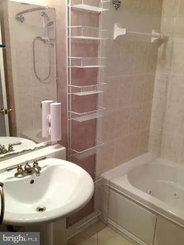 a backyard of a house with large trees and wooden fence