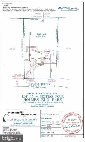 a front view of a house with a garden and trees