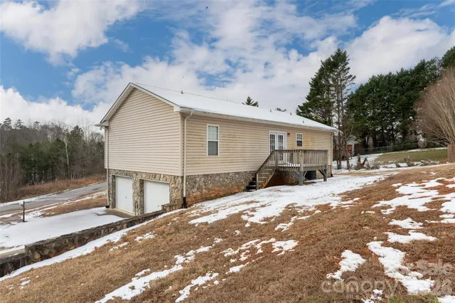 a view of a house with a yard covered in snow