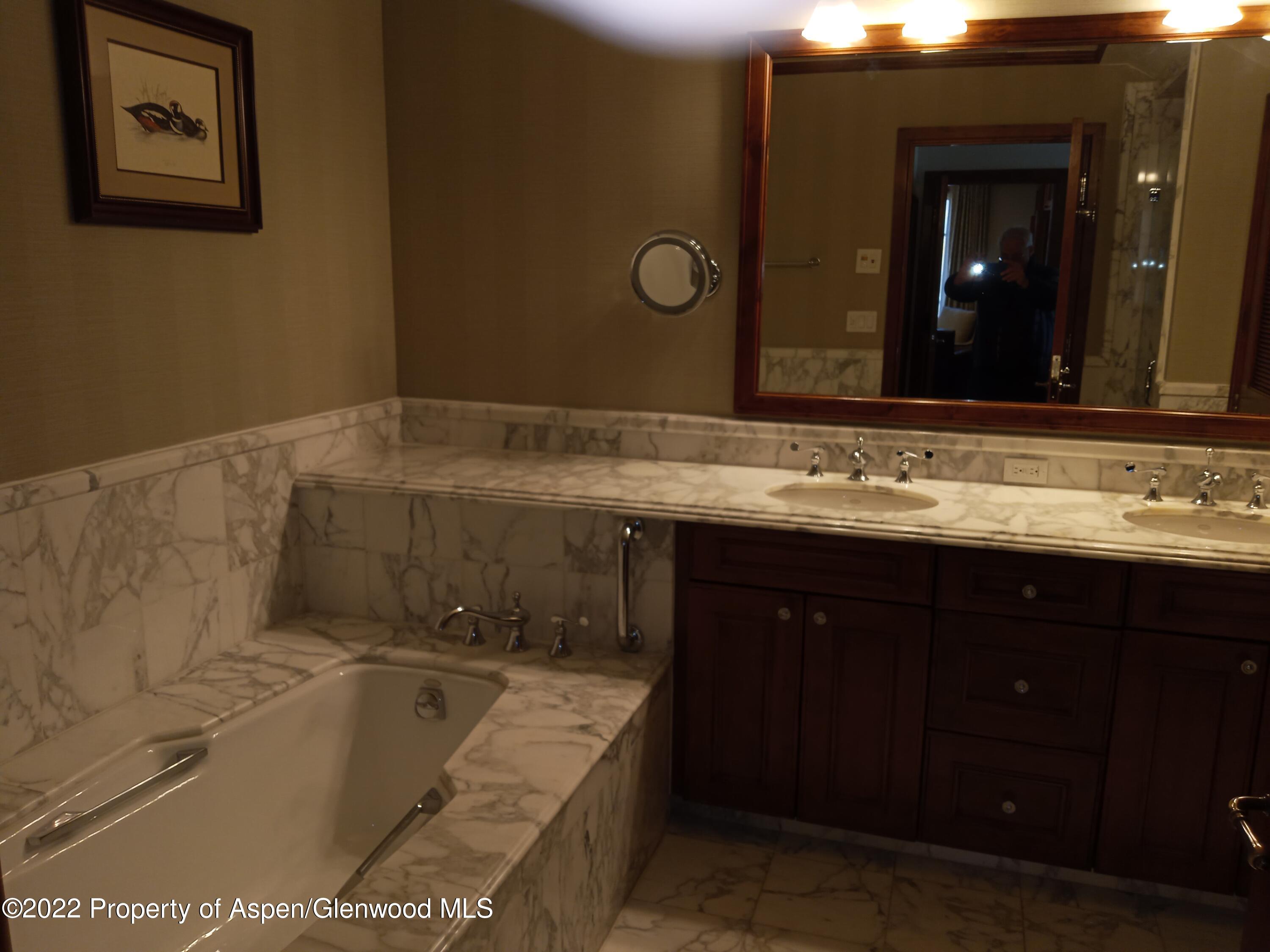 39 Boomerang Road, Unit 8415 SUMMER Aspen, CO 81611 - Photo 15 of 33 a bathroom with a tub sink and mirror