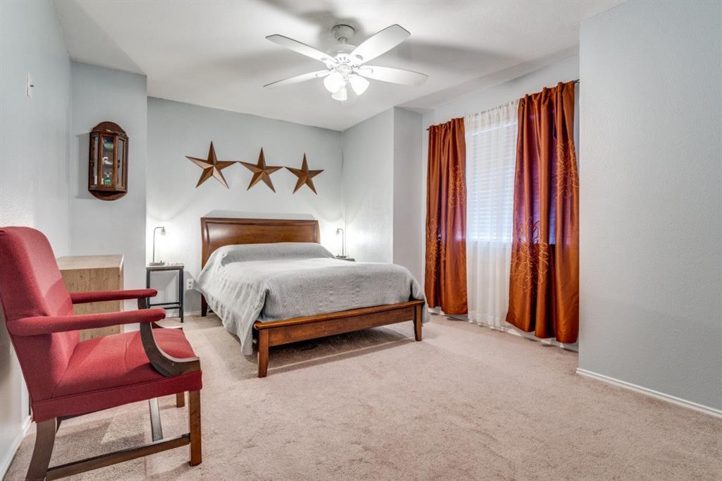 2031 Knights Court Allen, TX 75013 - Photo 10 of 12 a bedroom with a bed and a chandelier