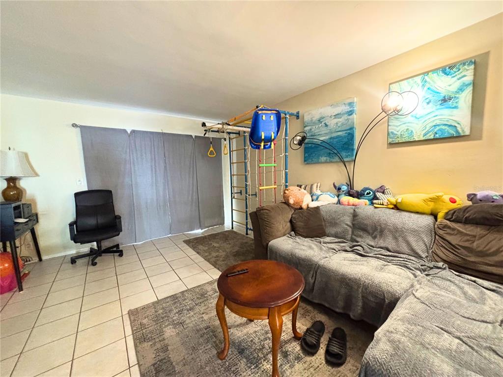 1433 South Belcher Road, Unit B2 Clearwater, FL 33764 - Photo 7 of 20 a living room with furniture and a rug