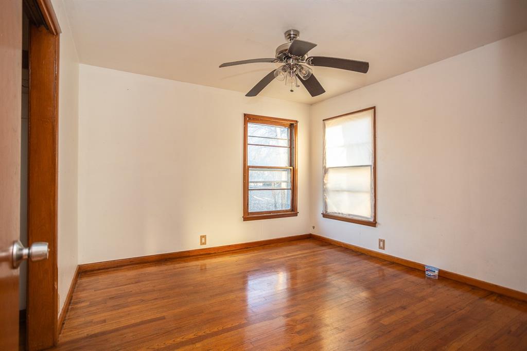 1414 Rice Avenue Gainesville, TX 76240 - Photo 12 of 21 a view of empty room with wooden floor and fan