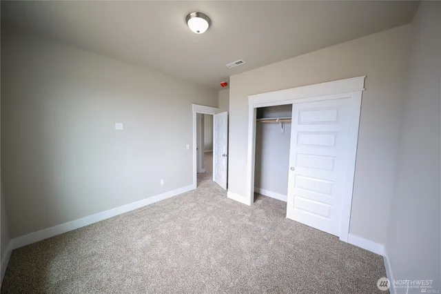 a view of an empty room and closet area
