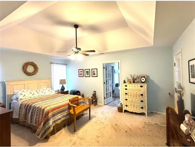 a bedroom with bed and a chandelier