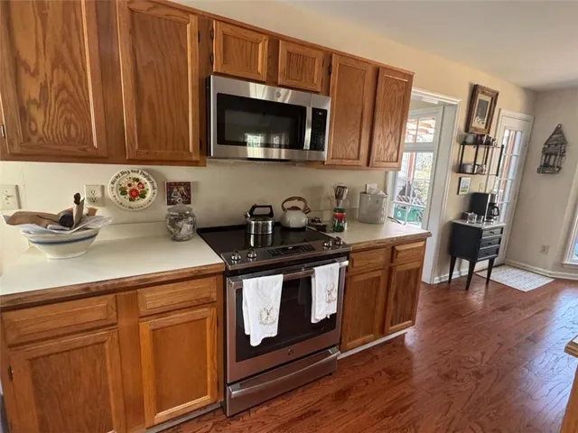 a kitchen with granite countertop cabinets and steel stainless steel appliances
