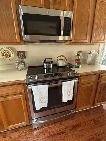 a kitchen with stainless steel appliances granite countertop wooden cabinets a sink and dishwasher
