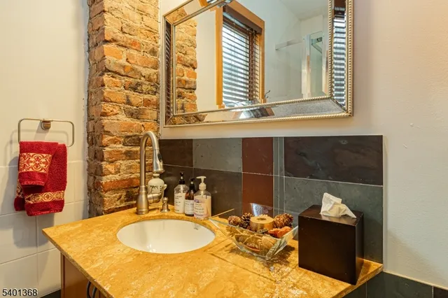 a bathroom with a sink and mirror