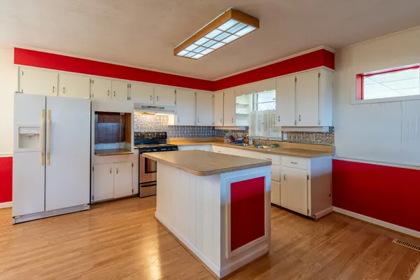 a kitchen with stainless steel appliances granite countertop a stove a refrigerator and a microwave