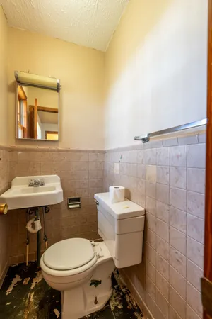 a bathroom with a sink toilet and a mirror