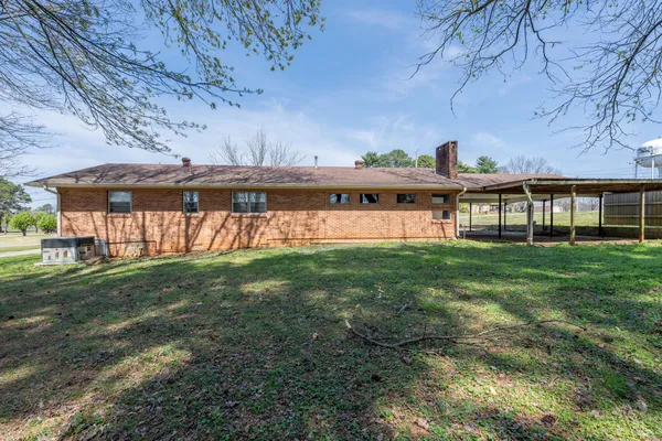 a backyard with pool table and chairs
