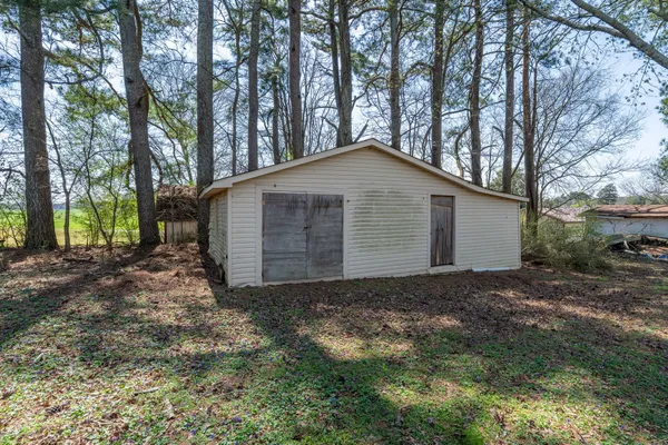 a view of backyard of house with green space
