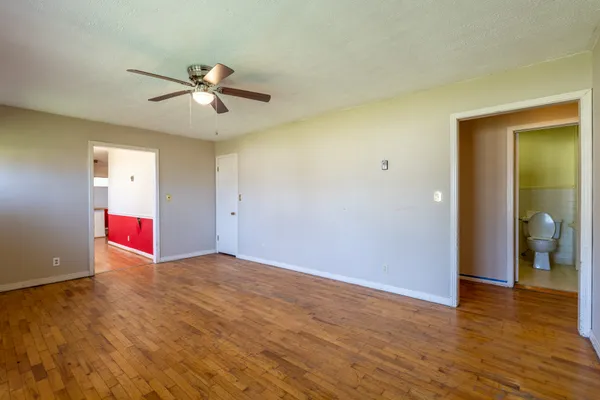 a view of an empty room with wooden floor