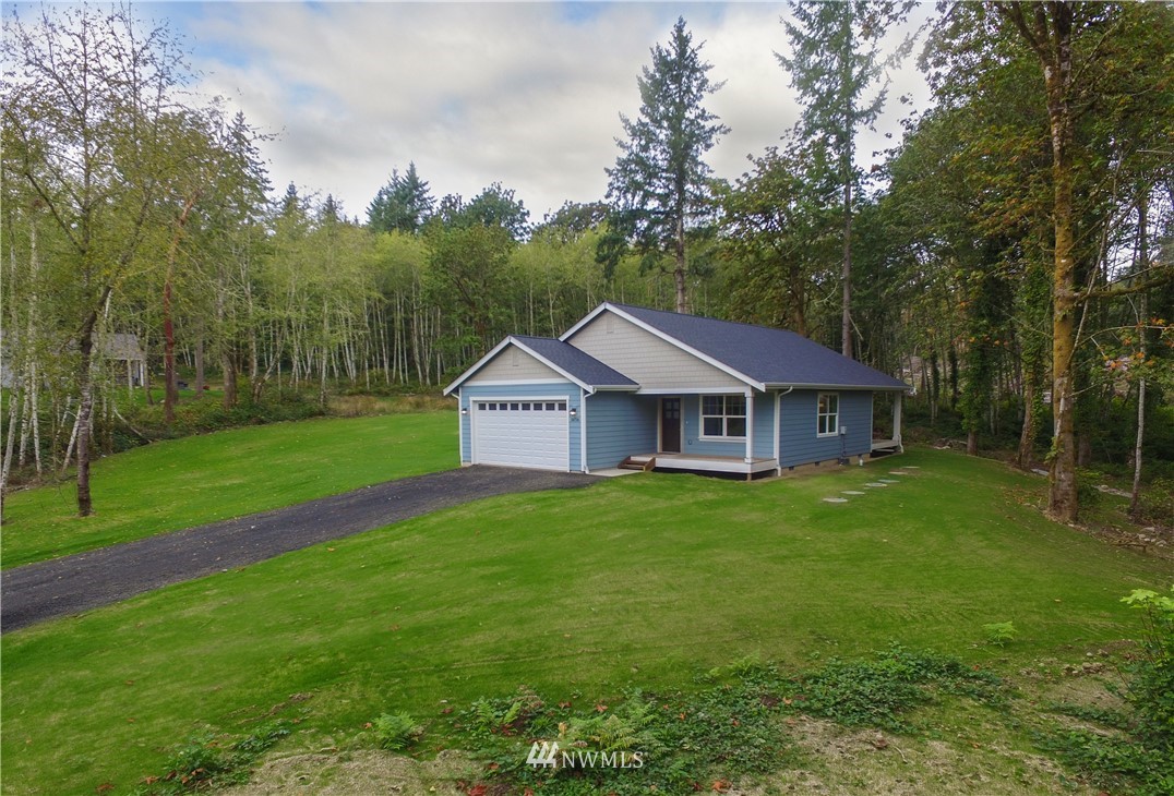 16716 Erickson Road Southwest Longbranch, WA 98351 - Photo 1 of 17 a front view of a house with garden