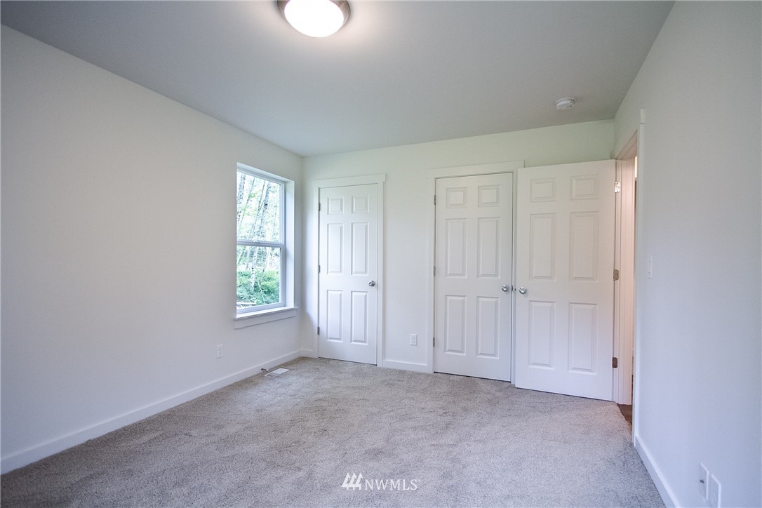 16716 Erickson Road Southwest Longbranch, WA 98351 - Photo 12 of 17 an empty room with windows and closet