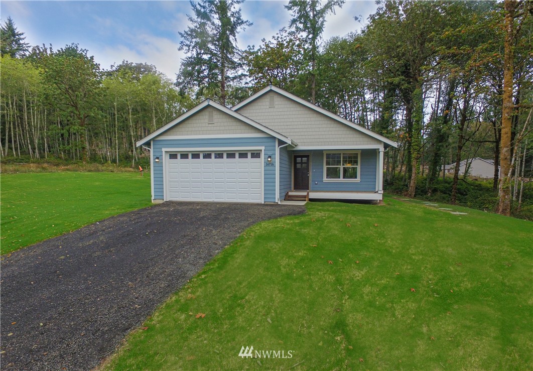 16716 Erickson Road Southwest Longbranch, WA 98351 - Photo 17 of 17 a view of a house with a yard and large trees
