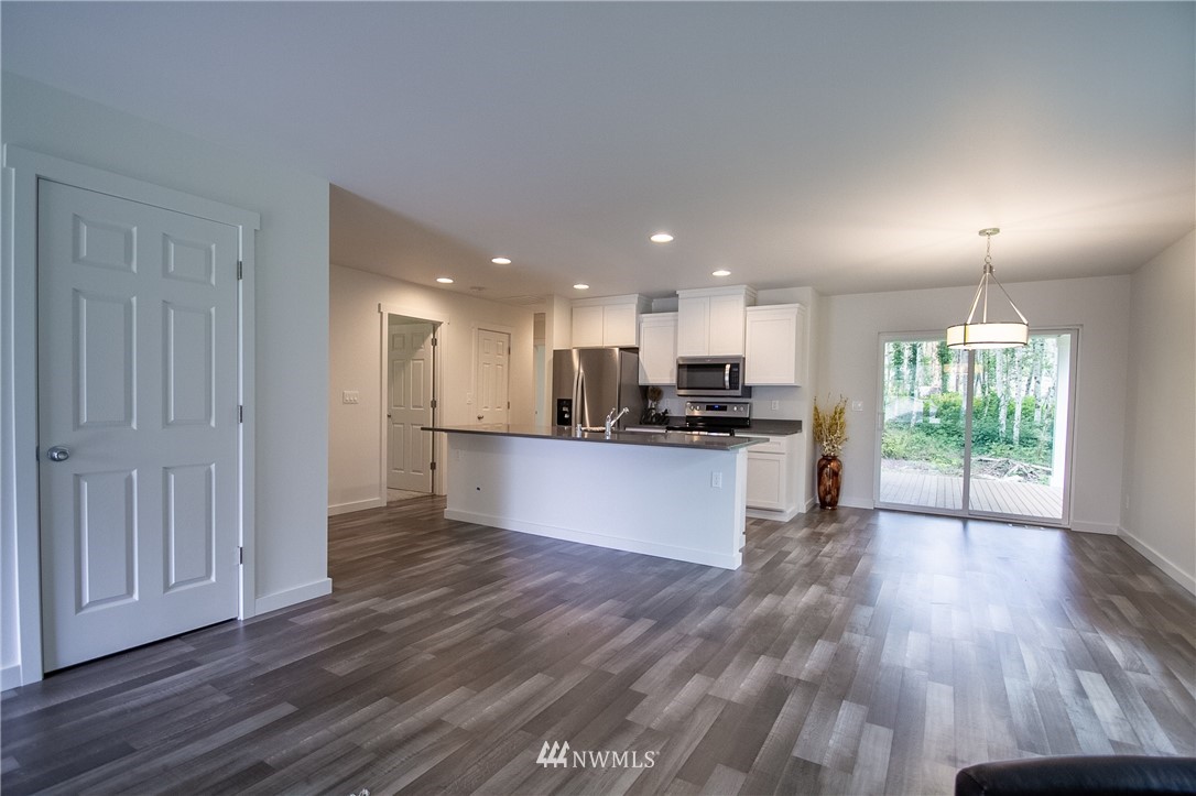 16716 Erickson Road Southwest Longbranch, WA 98351 - Photo 5 of 17 a view of kitchen with kitchen island wooden floors appliances and cabinets