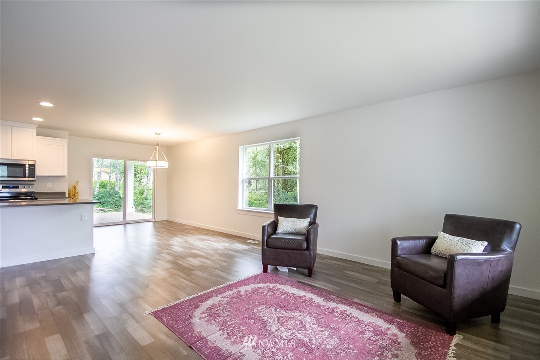 16716 Erickson Road Southwest Longbranch, WA 98351 - Photo 6 of 17 a living room with furniture and a wooden floor