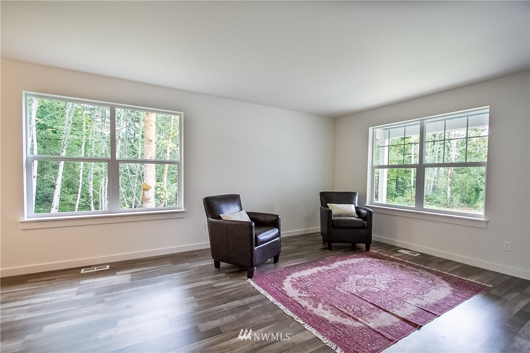 16716 Erickson Road Southwest Longbranch, WA 98351 - Photo 7 of 17 a living room with furniture rug and a window