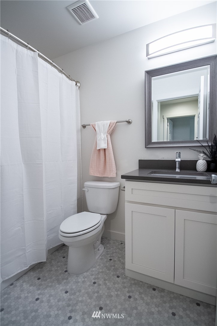 16716 Erickson Road Southwest Longbranch, WA 98351 - Photo 9 of 17 a bathroom with a toilet a sink and a mirror