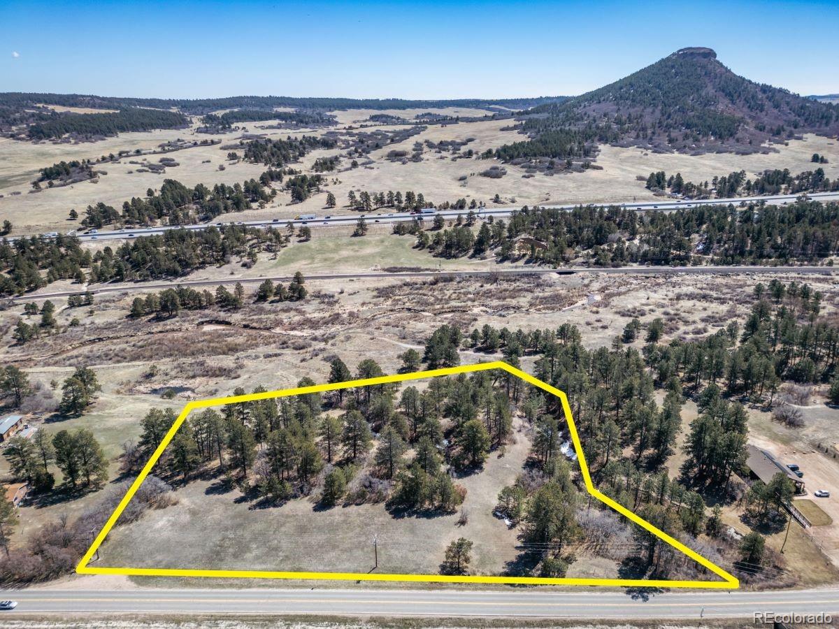 8650 Spruce Mountain Road Larkspur, CO 80118 - Photo 3 of 12 a view of a swimming pool with a lake view